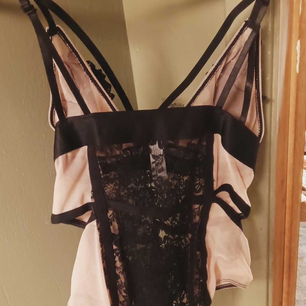 A beautiful black and light pink lace see through lingerie fits like a medium